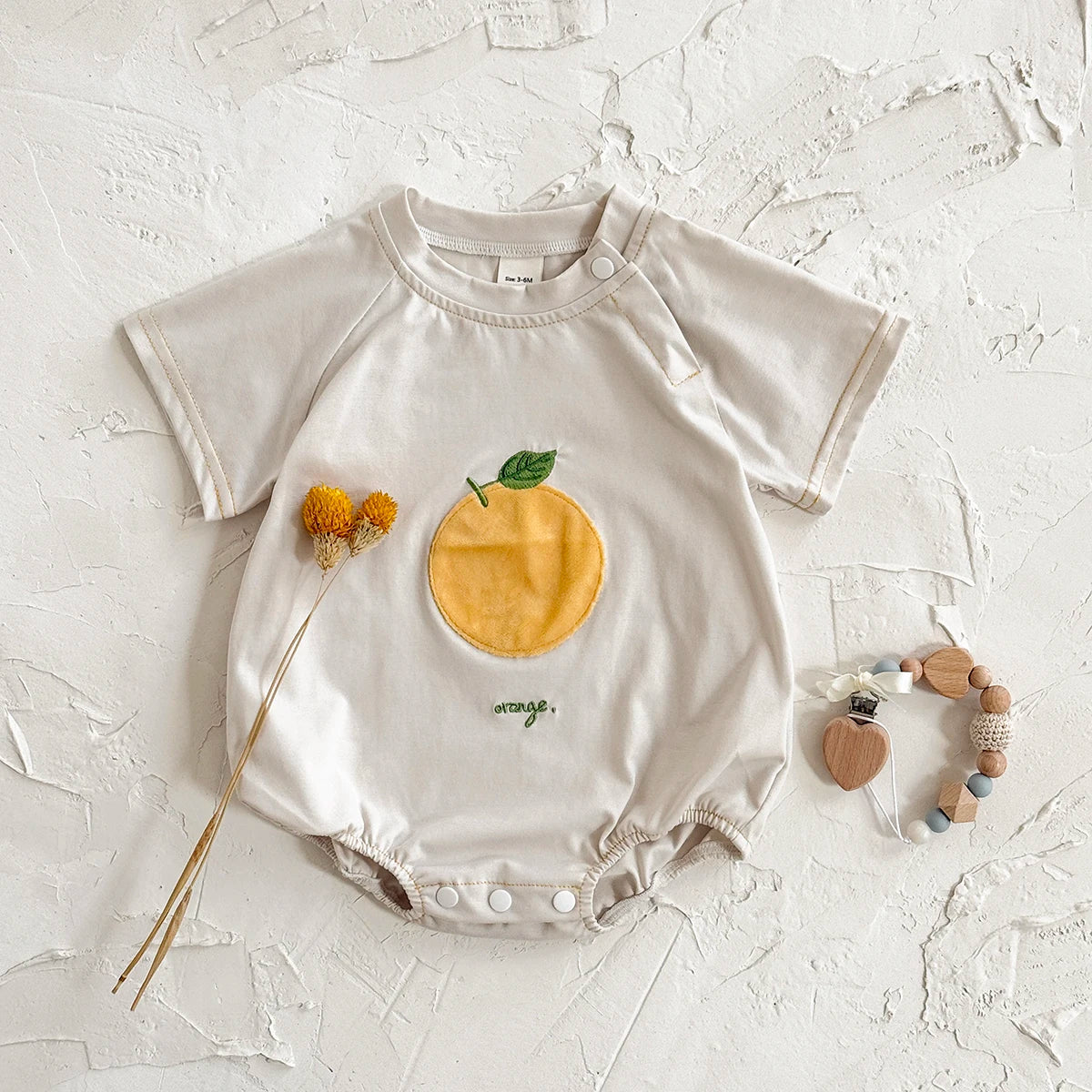 LittleMaylah™ Newborn Baby Bodysuit – Cotton Triangle Romper with Plush Letter Design (0–18M)